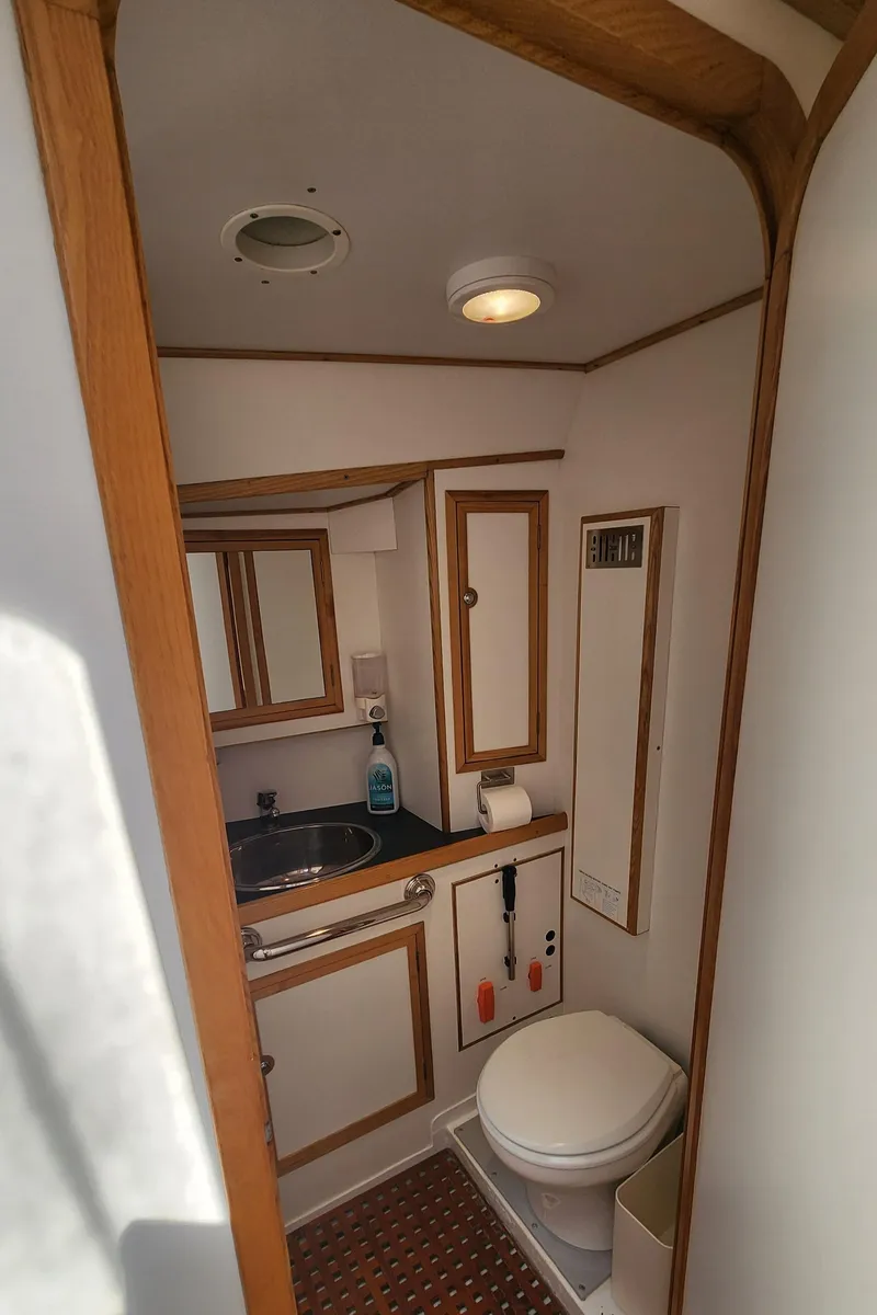 Slide: The Image of Compact bathroom in 2004 Dudley Dix Jacobs Bros 43 Pilot yacht, featuring sink, toilet, and wooden accents. - 41