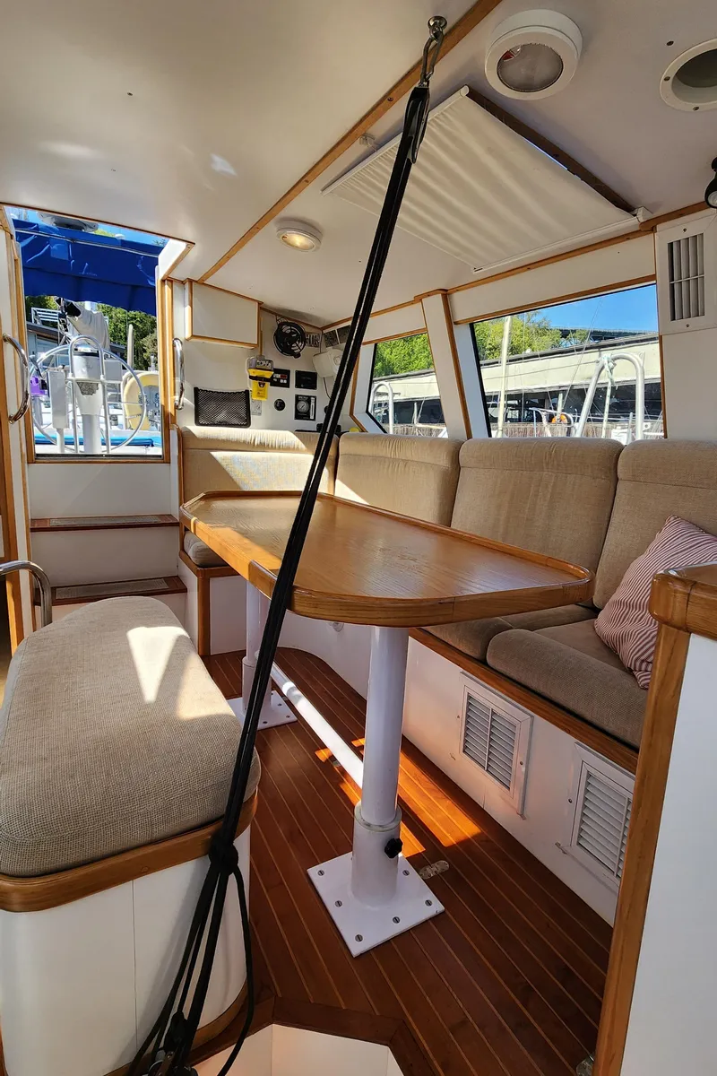 Slide: The Image of Interior of 2004 Dudley Dix Jacobs Bros 43 Pilot yacht with cozy seating and wooden table. - 37