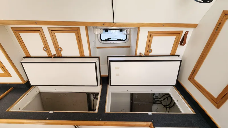 Slide: The Image of Interior of 2004 Dudley Dix Jacobs Bros 43 Pilot with open storage compartments. - 32