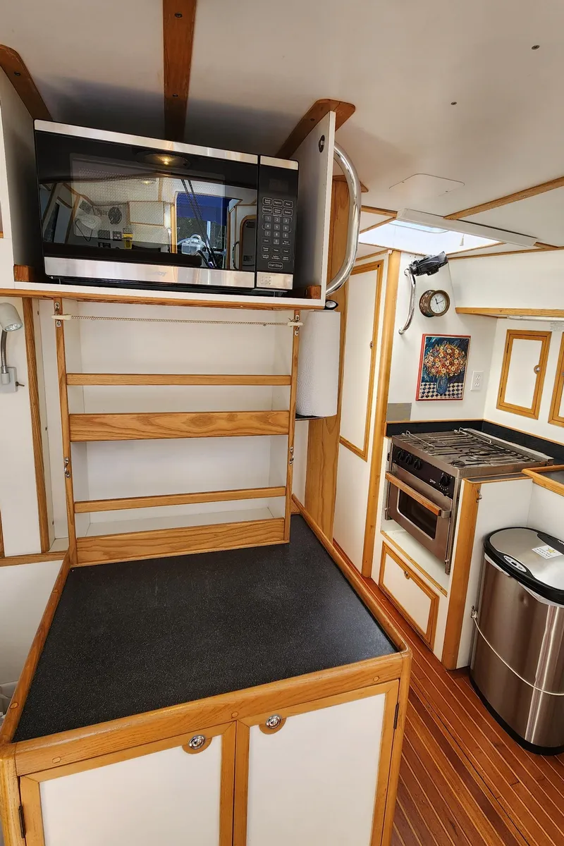 Slide: The Image of Compact kitchen in 2004 Dudley Dix Jacobs Bros 43 Pilot yacht with microwave and stove. - 34