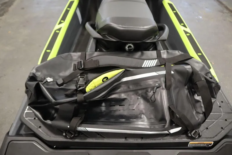 Slide: The Image of 2026 Sea-Doo Explorer Pro 170 with gear bag on seat, showcasing storage capacity. - 19