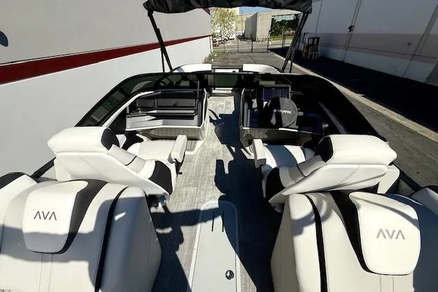 Slide: The Image of 2026 Avalon Catalina Quad Lounge 27' boat interior with luxurious white seating and modern design. - 10