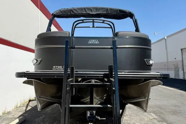 Slide: The Image of 2026 Avalon Catalina Quad Lounge 27' pontoon boat, rear view with ladder and canopy. - 14