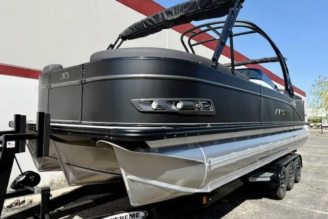 Slide: The Image of 2026 Avalon Catalina Quad Lounge 27' pontoon boat on trailer, sleek black design. - 16