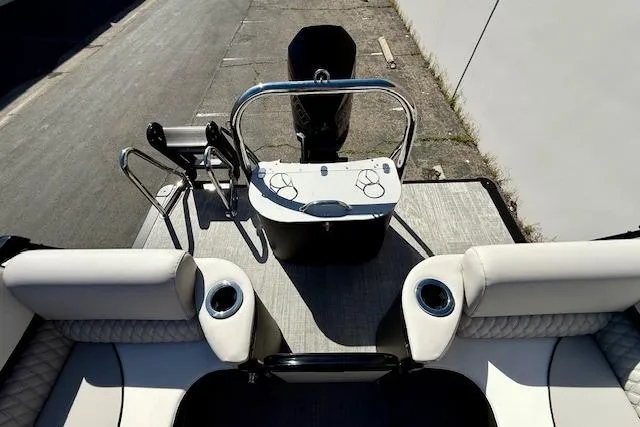 Slide: The Image of 2026 Avalon Catalina Quad Lounge boat interior with seating and control console. - 7