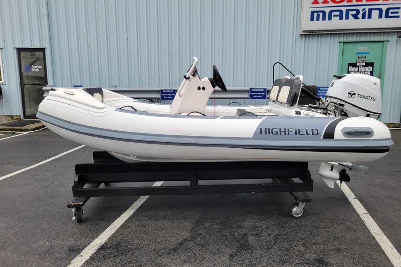 Slide: The Image of 2023 Highfield Sport 330 inflatable boat with Tohatsu engine on display. - 1