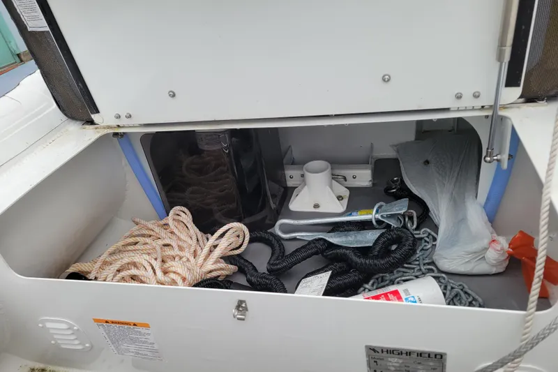 Slide: The Image of Storage compartment of 2023 Highfield Sport 330 boat with ropes and anchor equipment. - 12