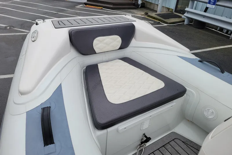 Slide: The Image of 2023 Highfield Sport 330 boat interior with cushioned seating and storage compartment. - 9