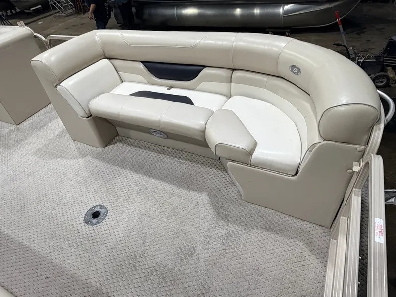Slide: The Image of 2006 Smoker Craft pontoon seating area, cream upholstery, carpeted floor. - 11