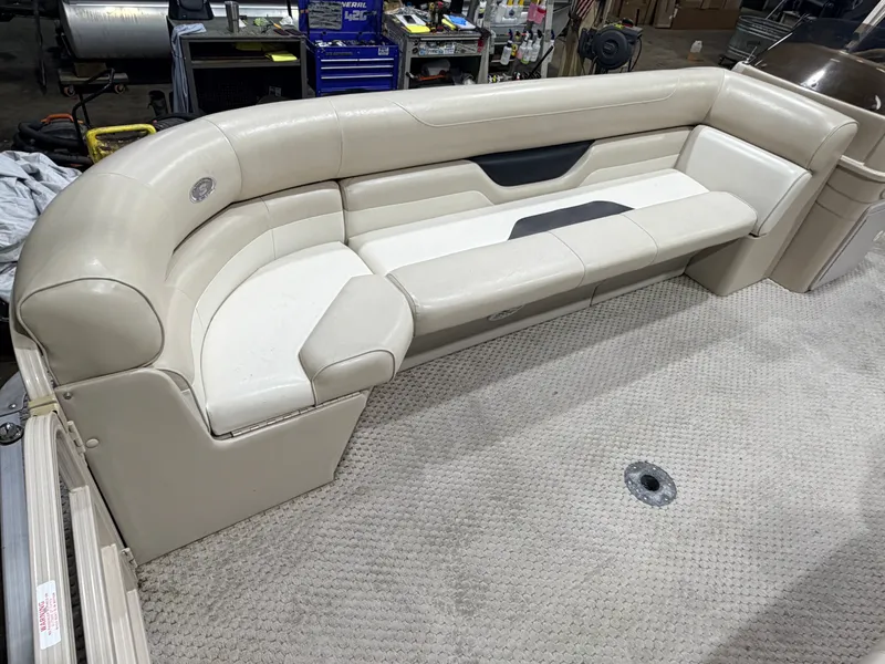 Slide: The Image of 2006 Smoker Craft pontoon with beige seating area, carpeted floor. - 14