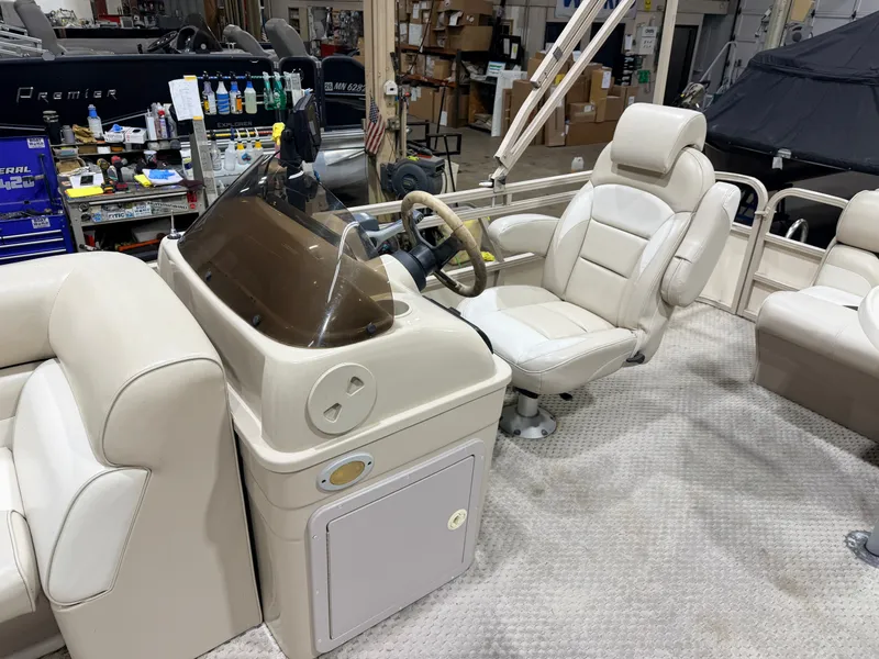Slide: The Image of Interior of a 2006 Smoker Craft 8522 Cruise Pontoon with helm console. - 17