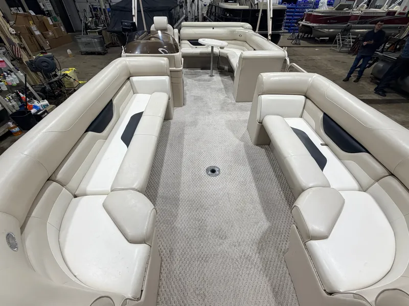 Slide: The Image of 2006 Smoker Craft pontoon with beige seating and carpeted floor. - 2