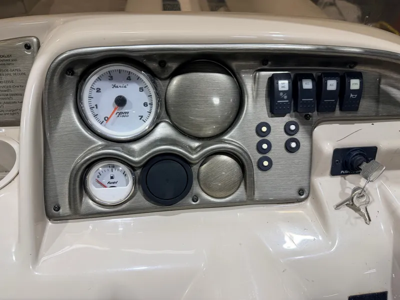 Slide: The Image of Dashboard of 2006 Smoker Craft 8522 pontoon boat with switches and gauges. - 23