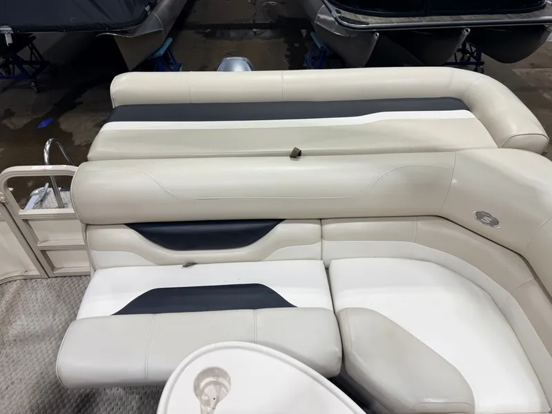 Slide: The Image of 2006 Smoker Craft pontoon with beige seating area. - 34