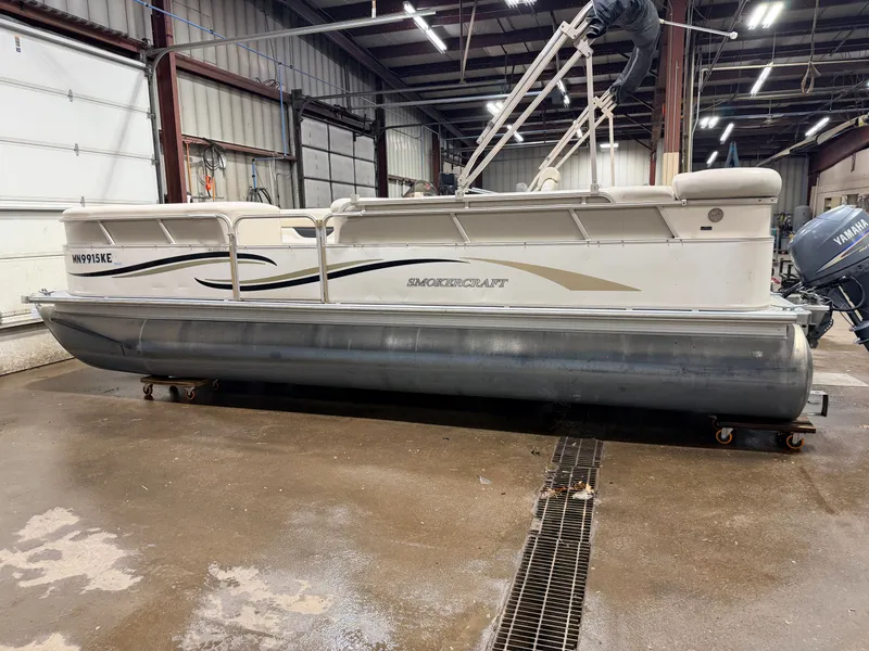 Slide: The Image of 2006 Smoker Craft pontoon boat with Yamaha 60HP 4-stroke engine in warehouse. - 39