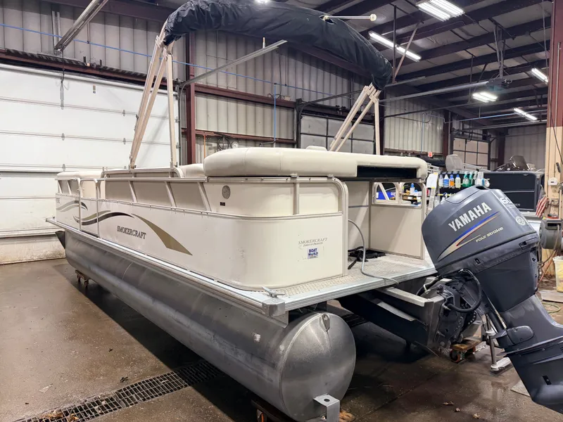 Slide: The Image of 2006 Smoker Craft pontoon boat with Yamaha 60HP engine in warehouse. - 41