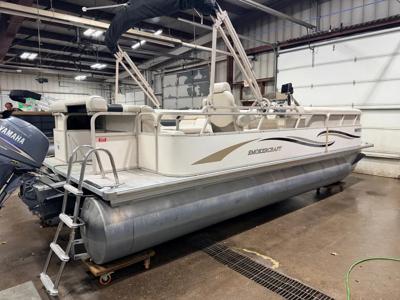 Slide: The Image of 2006 Smoker Craft pontoon boat with Yamaha 60HP 4-stroke engine in garage. - 43