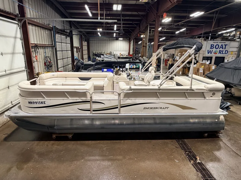 Slide: The Image of 2006 Smoker Craft pontoon boat with Yamaha 60HP 4-stroke engine in warehouse. - 5