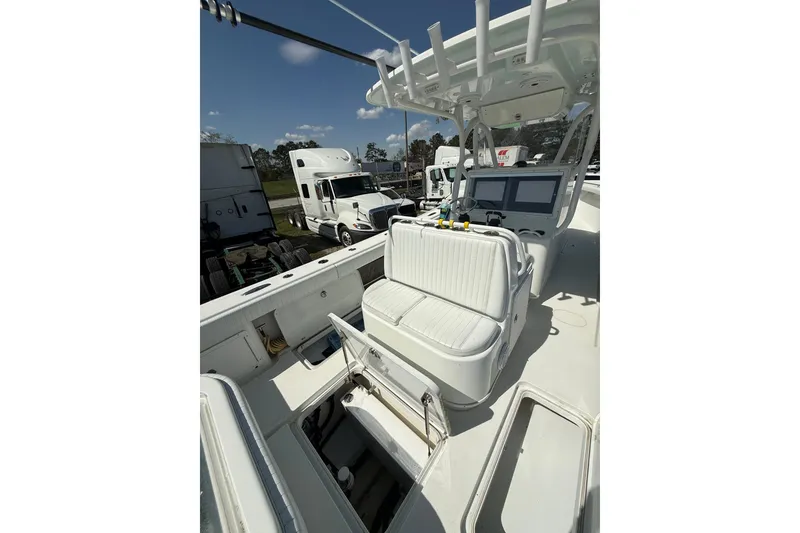 Slide: The Image of 2013 Yellowfin 32 Offshore boat interior with navigation screens and seating. - 16
