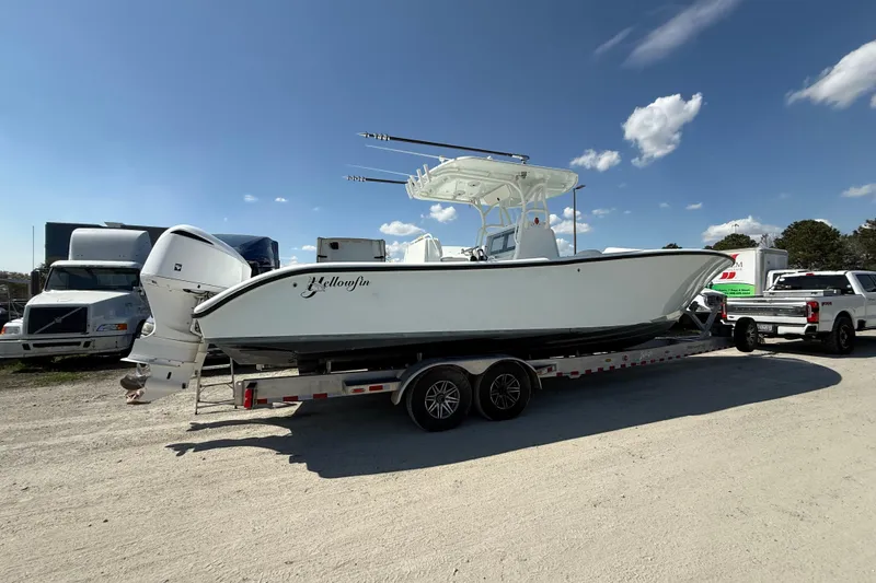 Slide: The Image of 2013 Yellowfin 32 Offshore boat interior with open storage compartment filled with drinks. - 22