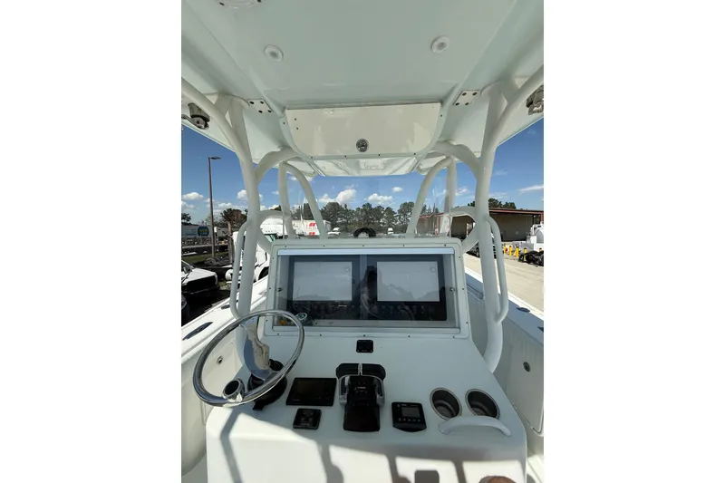 Slide: The Image of 2013 Yellowfin 32 Offshore boat dashboard with steering wheel and navigation equipment. - 8