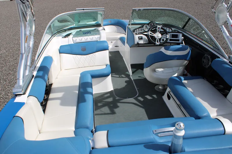 Slide: The Image of Interior of a 2013 MasterCraft X10 boat with blue and white seating. - 14