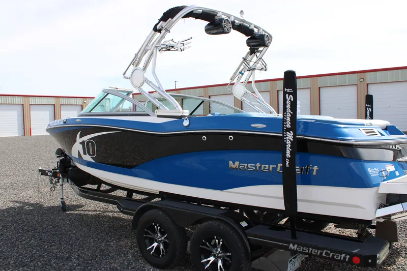 Slide: The Image of 2013 MasterCraft X10 boat on trailer, blue and black, in storage facility. - 5