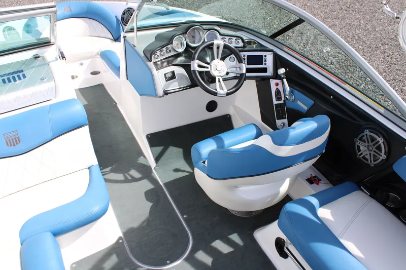 Slide: The Image of Interior of a 2013 MasterCraft X10 boat with blue seating. - 6
