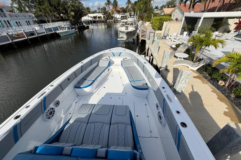 Slide: The Image of Luxury Midnight Express 43 Open boat docked in a scenic canal setting. - 2