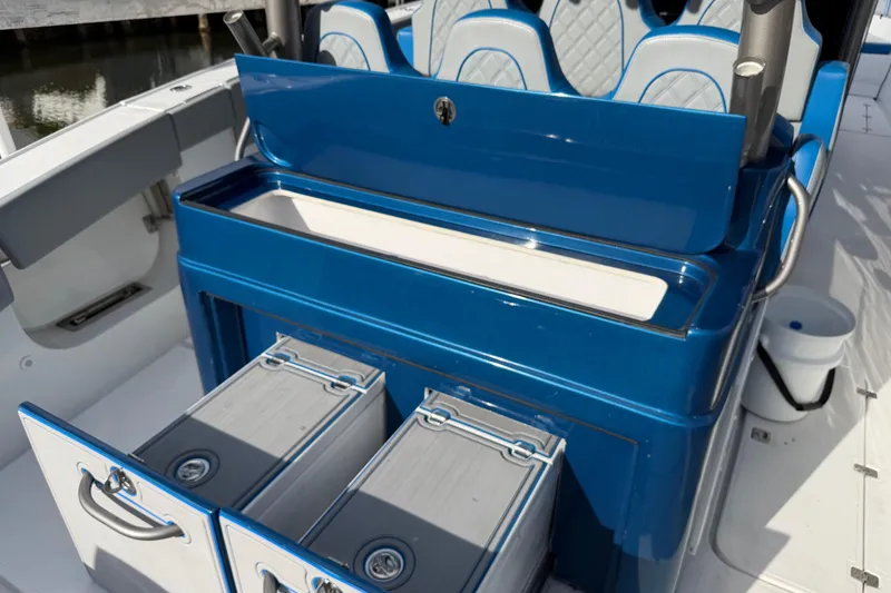 Slide: The Image of Blue seating and storage area on a Midnight Express 43 Open boat. - 8