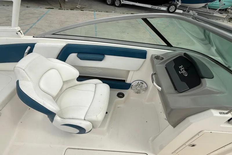 Slide: The Image of 2016 Chaparral H20 21 Deluxe boat interior with white and blue seating. - 10