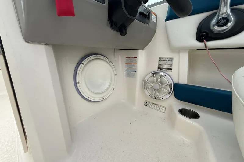 Slide: The Image of Interior of 2016 Chaparral H20 21 Deluxe boat showing speaker and control panel. - 13