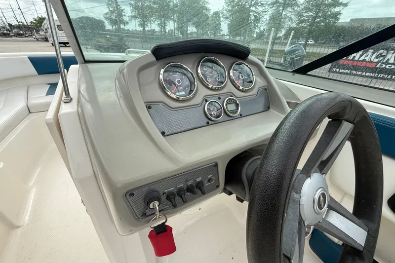 Slide: The Image of 2016 Chaparral H20 21 Deluxe boat dashboard with steering wheel and gauges. - 15