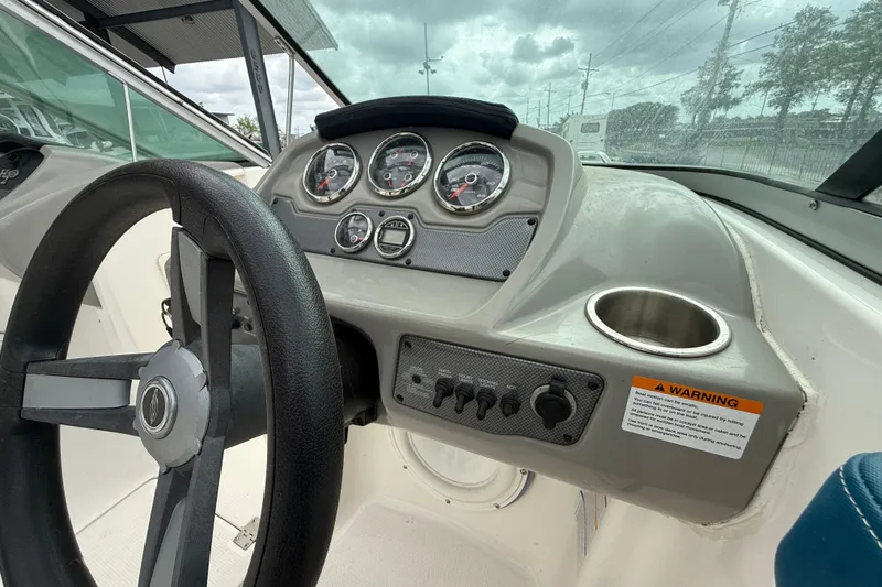 Slide: The Image of 2016 Chaparral H20 21 Deluxe boat dashboard with steering wheel and gauges. - 16