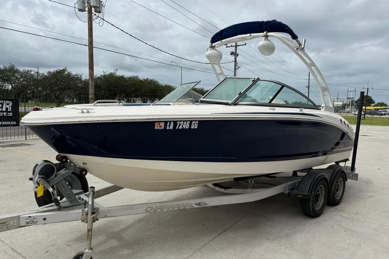 Slide: The Image of 2016 Chaparral H20 21 Deluxe boat on trailer, parked outdoors under cloudy sky. - 3