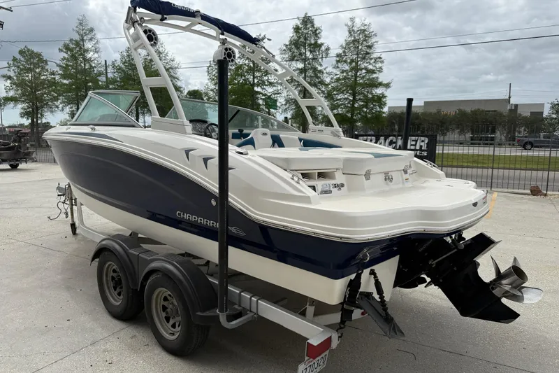 Slide: The Image of 2016 Chaparral H20 21 Deluxe boat on trailer, parked outdoors. - 4