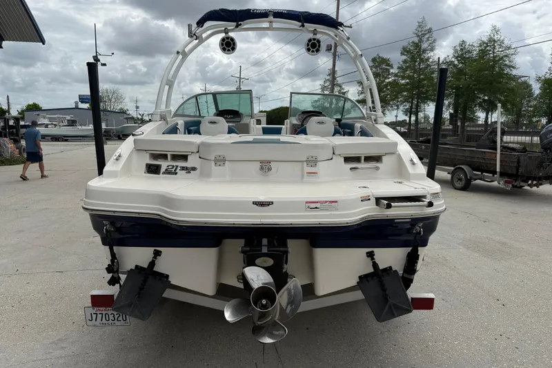 Slide: The Image of 2016 Chaparral H20 21 Deluxe boat, rear view, parked outdoors on a cloudy day. - 5