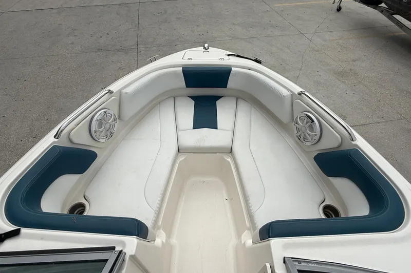 Slide: The Image of 2016 Chaparral H20 21 Deluxe boat interior with blue and white seating. - 8