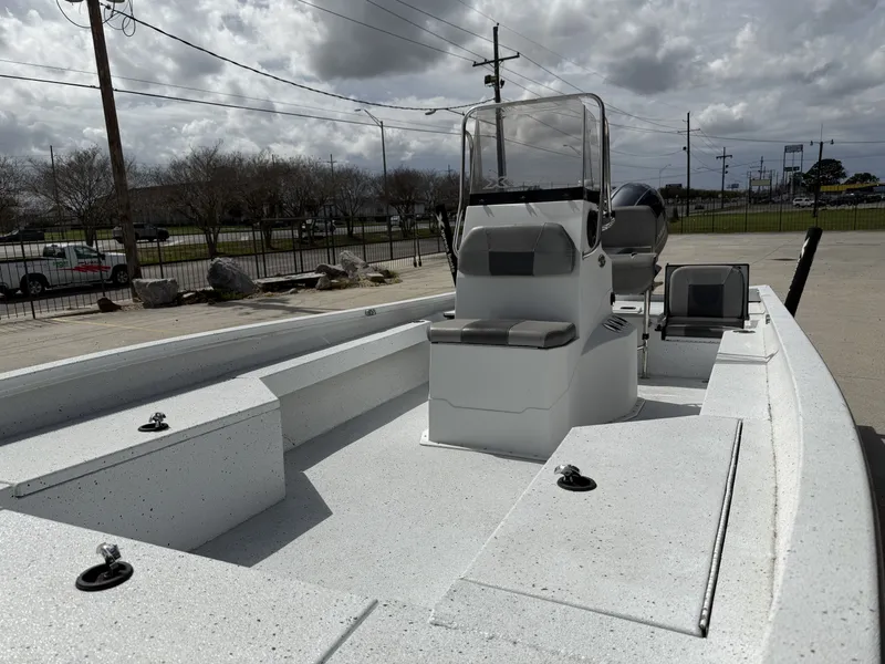 Slide: The Image of 2021 Xpress H24B Bay boat on parking lot under cloudy sky. - 10
