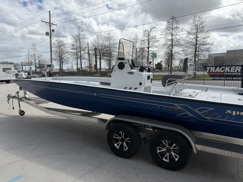 Slide: The Image of 2021 Xpress H24B Bay boat on trailer, blue hull. - 6