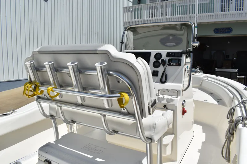 Slide: The Image of 2022 Key West 219 FS boat interior with helm, rod holders, and seating. - 11