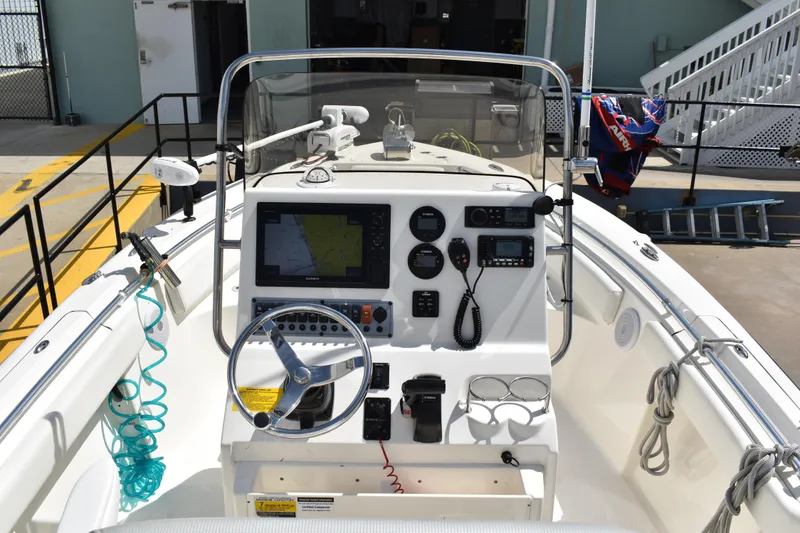 Slide: The Image of 2022 Key West 219 FS boat dashboard with navigation equipment and steering wheel. - 15