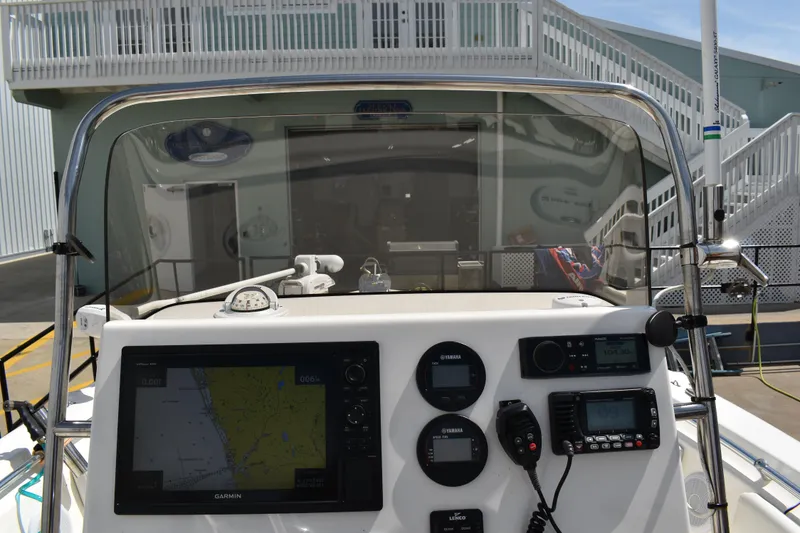 Slide: The Image of 2022 Key West 219 FS boat dashboard with navigation and control instruments. - 16