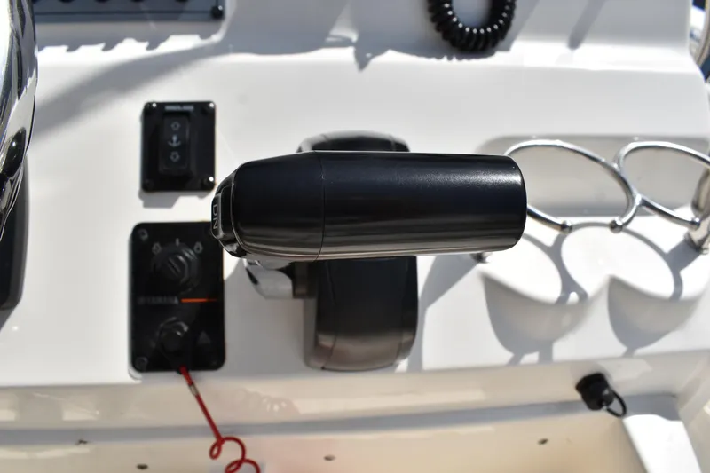 Slide: The Image of Throttle control on 2022 Key West 219 FS boat dashboard with cup holders. - 22