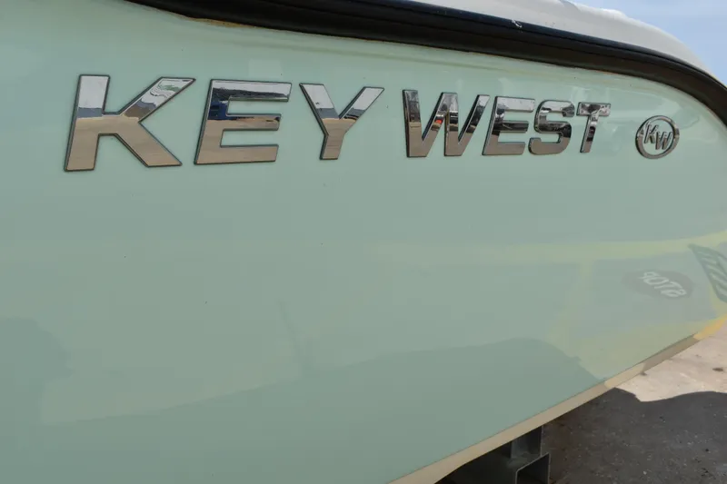 Slide: The Image of Key West 219 FS 2022 boat logo on light-colored hull. - 3