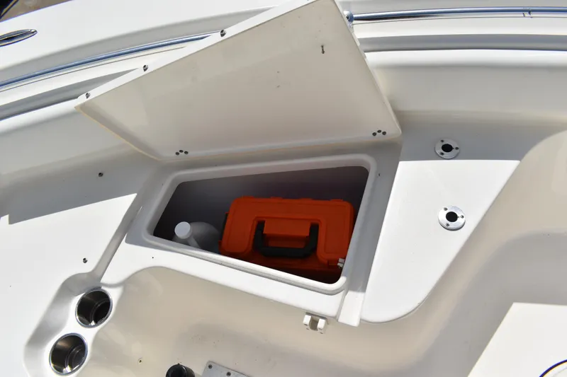 Slide: The Image of Open storage compartment on 2022 Key West 219 FS boat with orange case inside. - 31