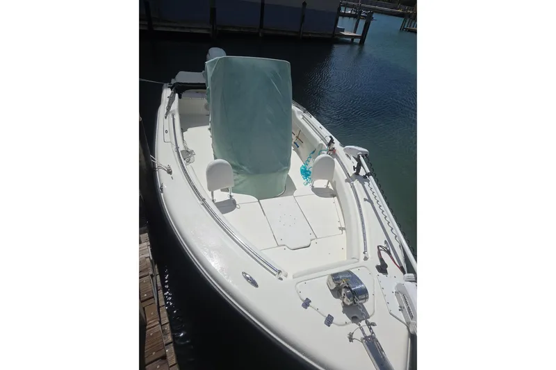 Slide: The Image of 2022 Key West 219 FS boat docked, featuring a covered console and spacious deck. - 34