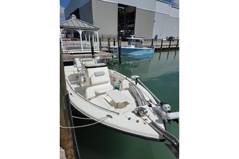 Slide: The Image of 2022 Key West 219 FS boat docked at marina with calm water. - 35