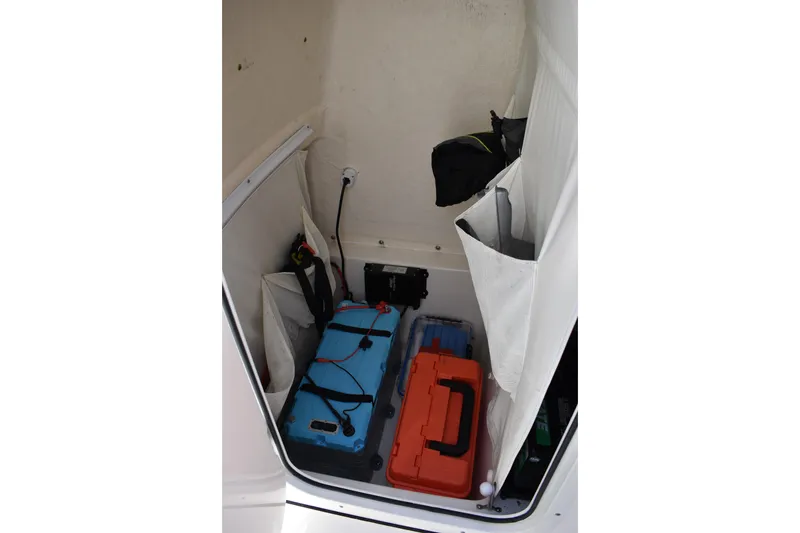 Slide: The Image of Storage compartment in a 2022 Key West 219 FS boat with organized gear and equipment. - 39