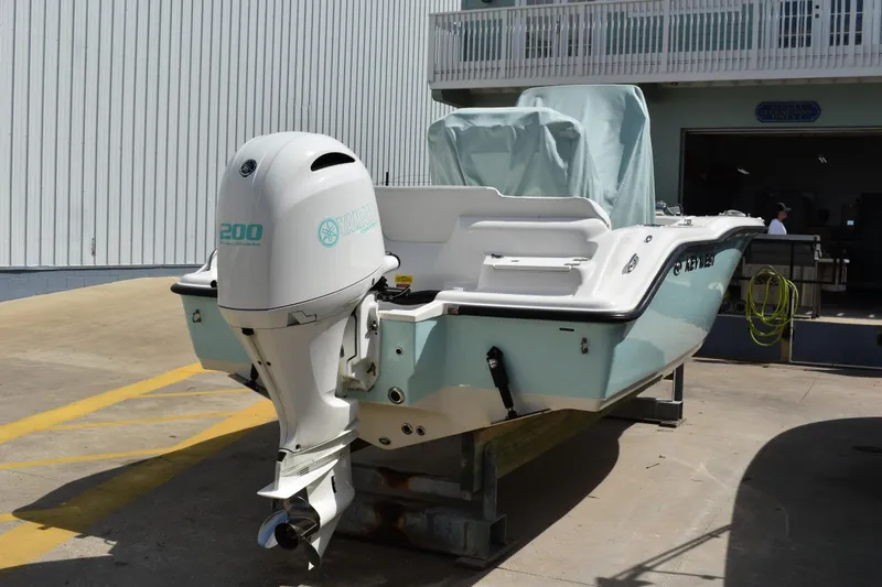 Slide: The Image of 2022 Key West 219 FS boat with Yamaha 200 engine, docked outdoors. - 40